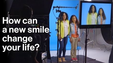 a mother and daughter in a camera studio with the caption - How can a new smile change your life?