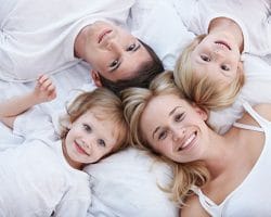 a family looking up smiling