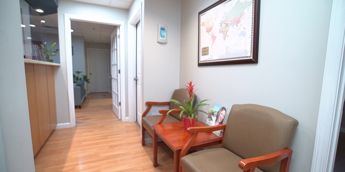 waiting area with two chairs and world map hanging on wall