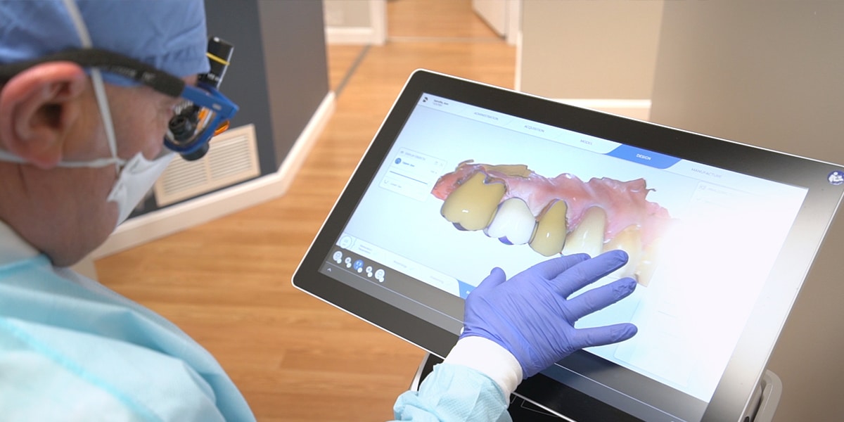 dentist viewing digital x-ray on touch screen monitor